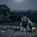 Un jardinier semant des graines sous la lune, illustrant le jardinage selon les cycles lunaires.